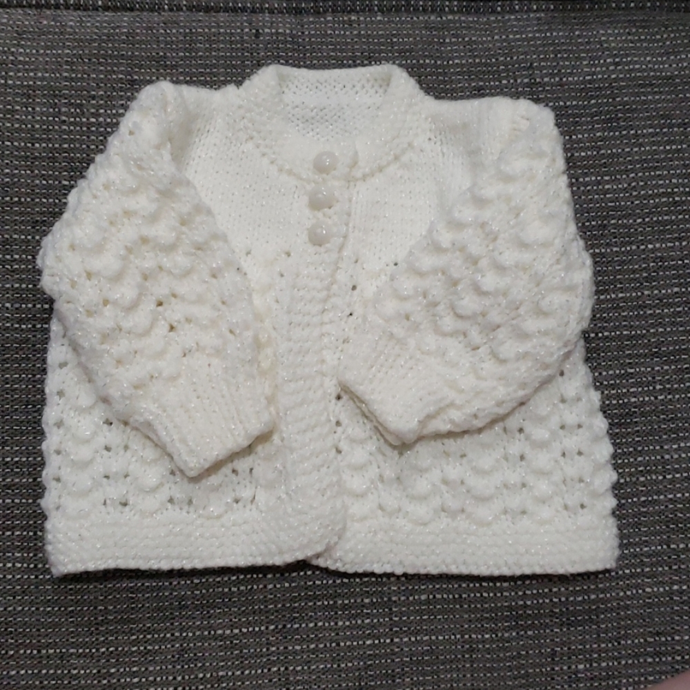 White knitted newborn sweater